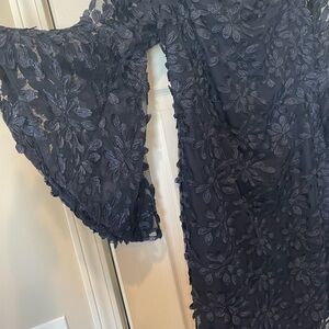 Navy off the shoulder mini dress with lace wide sleeves.